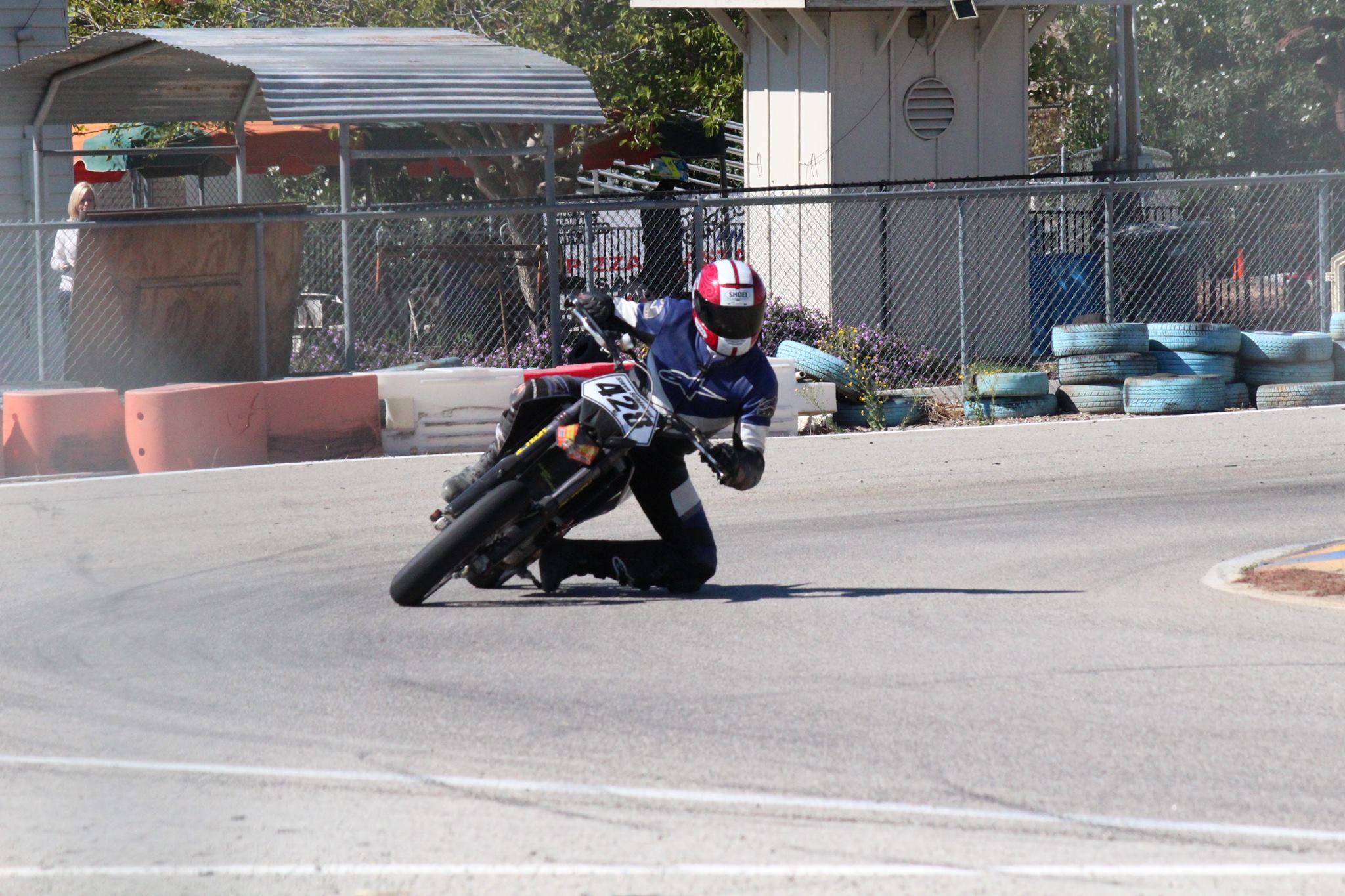 Supermoto knee-down cornering at a local track