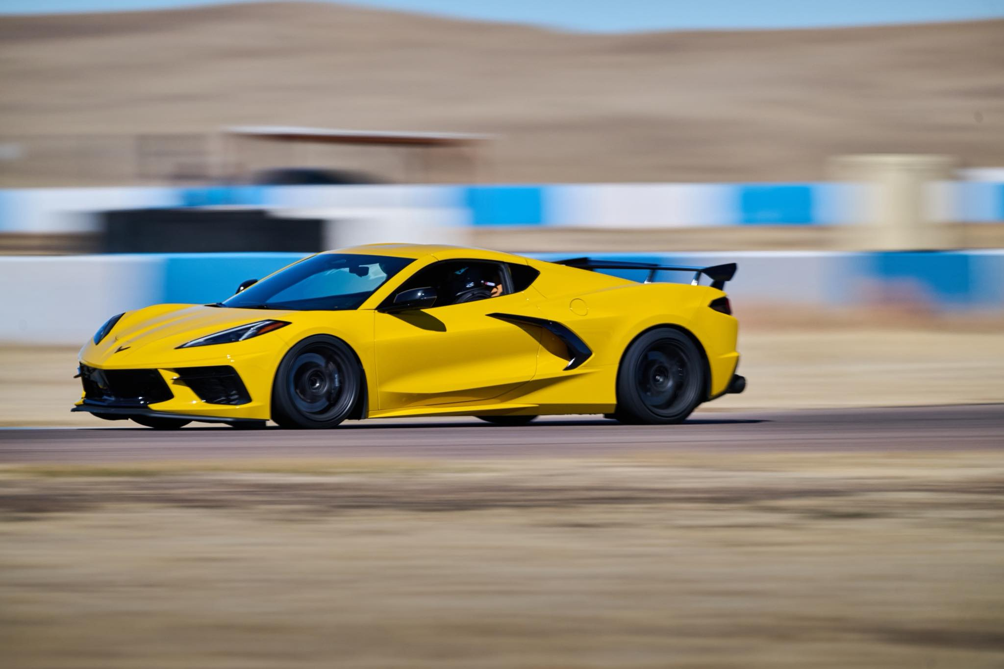 Yellow Corvette C8 on track with motion blur