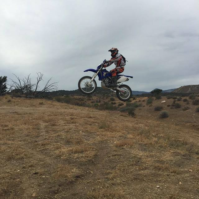 Dirt bike jumping over desert terrain