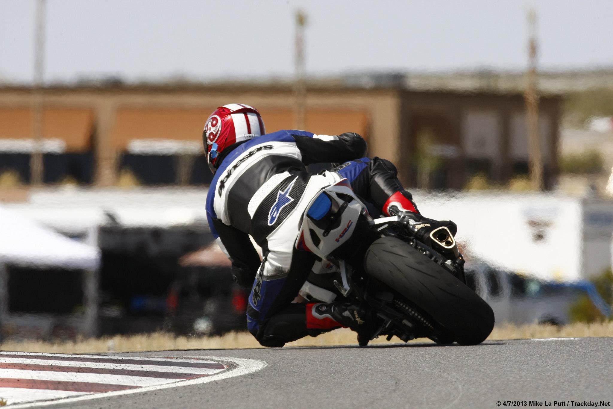 Honda CBR leaning into a racetrack corner